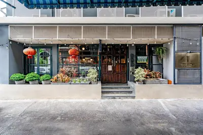 a store front of a building with potted plants at Tim Mansion in Bangkok