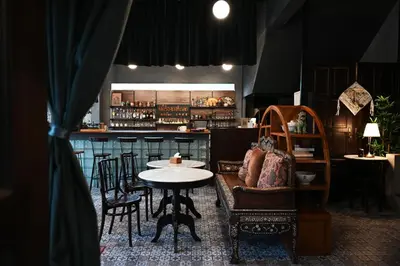 a restaurant with a table and chairs and a bar at Tim Mansion in Bangkok