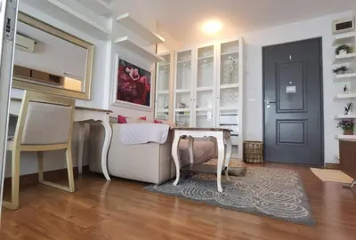 a living room with a couch and a door at Rama9 Cozy Apartment in Bangkok