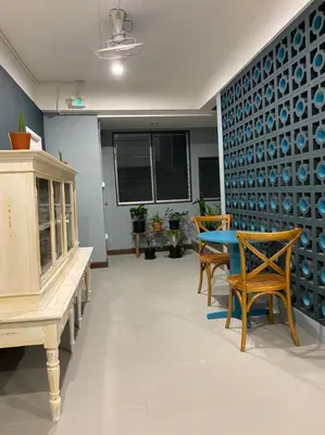 a dining room with a table and chairs at Grasshopper Bed and Cafe in Pak Kret