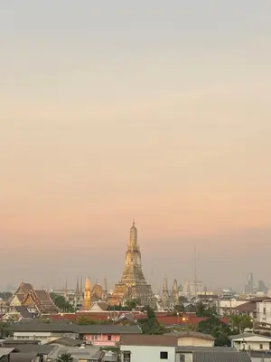 a view of a temple in a city at sunset at Baan Suandao Wat Arun in Bangkok