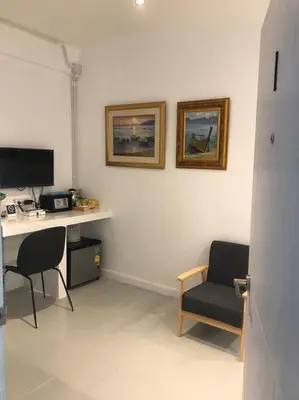 a room with a desk and a chair and a computer at Baan Suandao Wat Arun in Bangkok