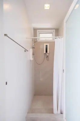 a bathroom with a shower with a shower curtain at Siamaze Hostel in Bangkok