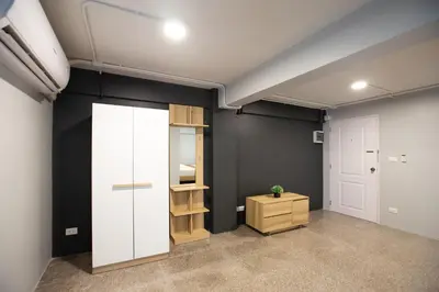 a room with black walls and a white door at 185@Surawong Residence in Bangkok
