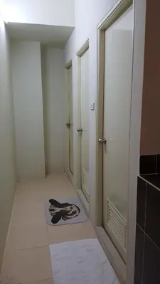 a hallway with a cat laying on a rug on the floor at Bangkok Check Inn @Chareon Krung in Bangkok
