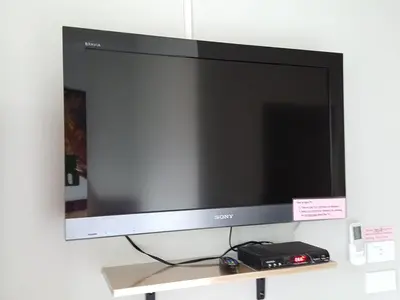 a flat screen tv sitting on a shelf at Bangkok Check Inn @Chareon Krung in Bangkok