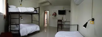 a room with two bunk beds and a kitchen at Bangkok Check Inn @Chareon Krung in Bangkok