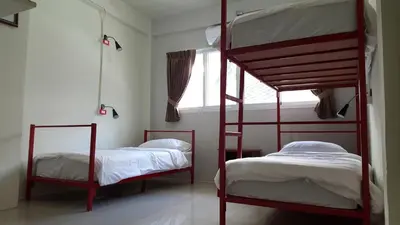 a bedroom with two bunk beds and a window at Bangkok Check Inn @Chareon Krung in Bangkok