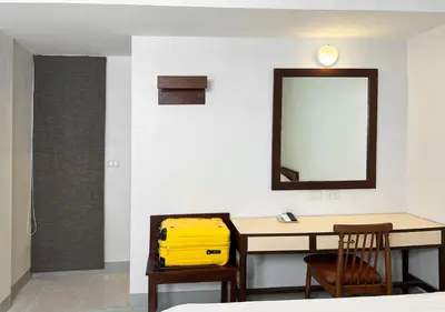 a room with a table with a yellow bag on it at Niagara Hotel in Bangkok