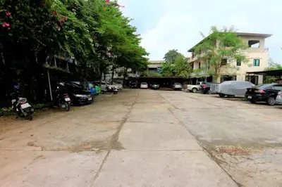 an empty parking lot with cars parked on the street at Platinum Place in Bangkok