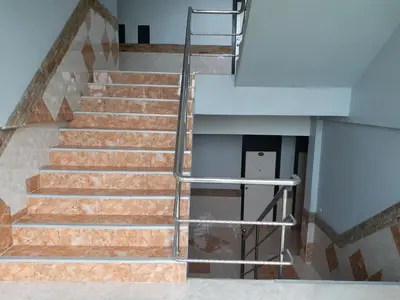 a staircase with a metal handrail in a building at Platinum Place in Bangkok