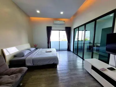 a bedroom with a bed and a couch and a television at Aqua Residences อควา เรสซิเดนซ์ ห้องพักใหม่ให้เช่า ติดรถไฟฟ้าสถานีวุฒากาศ in Bangkok