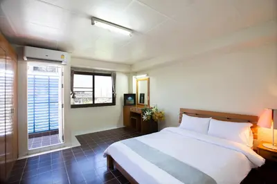 a bedroom with a large bed and a window at D haus Ngamwongwan Residence in Nonthaburi