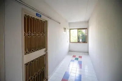 an empty hallway with a door and a window at D haus Ngamwongwan Residence in Nonthaburi