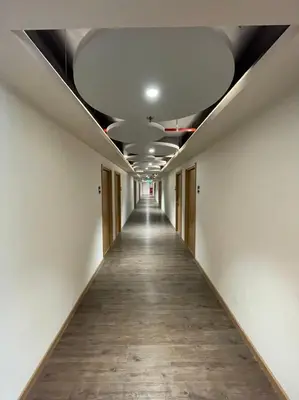 an empty corridor in an office building with a ceiling at The Neuf@Ratchada in Bangkok