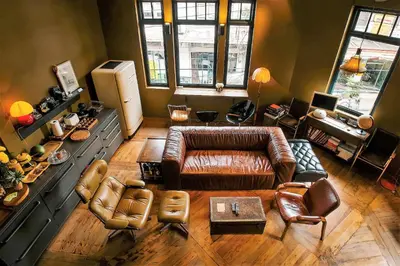 a living room with a leather couch and chairs at Ba Hao Residence in Bangkok