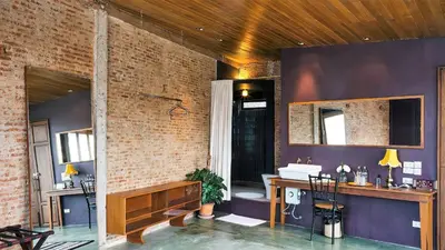 a bathroom with a sink in a brick wall at Ba Hao Residence in Bangkok