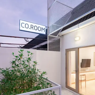 a sign that reads go room on the side of a building at COROOM BKK in Bangkok