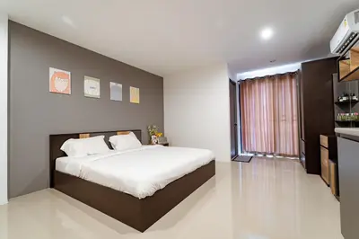 a bedroom with a large bed and a large window at My Space @ Chaosua69 in Ban Pak Khlong Khwang