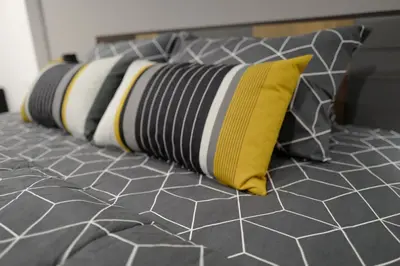 a row of pillows sitting on top of a bed at My Space @ Chaosua69 in Ban Pak Khlong Khwang
