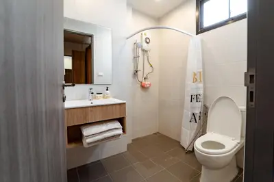 a bathroom with a toilet and a sink and a shower at My Space @ Chaosua69 in Ban Pak Khlong Khwang
