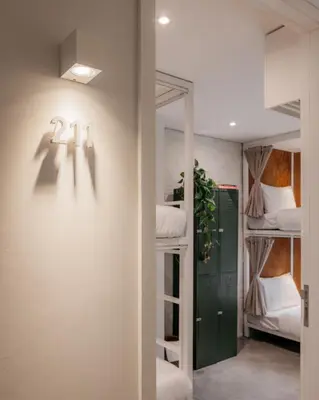 a hallway with bunk beds and a door to a room at Tamni in Bangkok