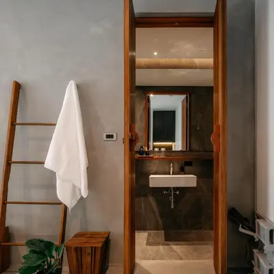 a bathroom with a sink and a mirror at Tamni in Bangkok