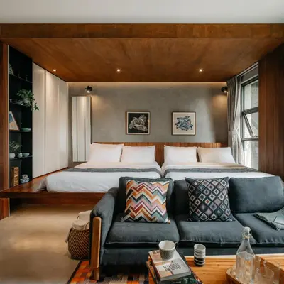 a bedroom with a large bed and a couch at Tamni in Bangkok