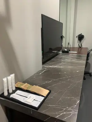 a bathroom counter with a mirror and a counter top with a counter sidx sidx at 515 VICTORY Hotel in Pom Prap