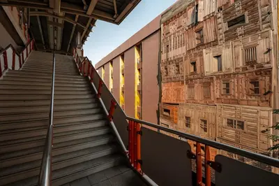 a staircase in a building next to a wall at 515 VICTORY Hotel in Pom Prap