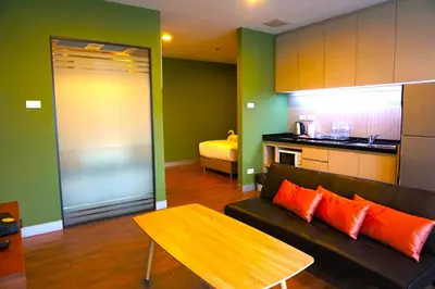 a living room with a couch and a table at Nest n Rest Hotel in Ban Bang Toei (1)