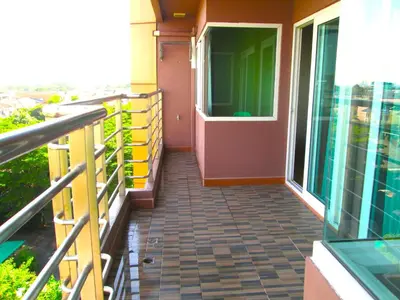 a balcony with a door on a building at Nest n Rest Hotel in Ban Bang Toei (1)