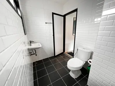 a bathroom with a toilet and a sink at WiRE BANGKOK PRAKHANONG in Amphoe Phra Khanong