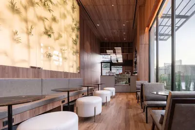 a restaurant with tables and chairs and windows at Wyndham Garden Bangkok Sukhumvit 42 in Bangkok