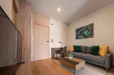 a living room with a couch and a table at Wyndham Garden Bangkok Sukhumvit 42 in Bangkok