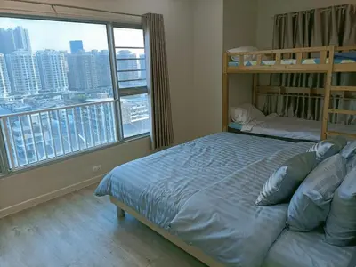 a bedroom with two bunk beds and a large window at Harmony family room in Bangkok