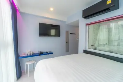 a bedroom with a white bed and a window at Spark Hotel - MRT Queen Sirikit - SHA Extra Plus Certified in Bangkok