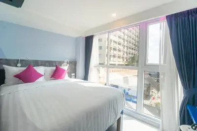 a bedroom with a bed and a large window at Spark Hotel - MRT Queen Sirikit - SHA Extra Plus Certified in Bangkok