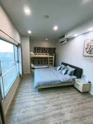 a bedroom with a bed and a large window at \u6eab\u99a8\u5c0f\u5c4b in Bangkok