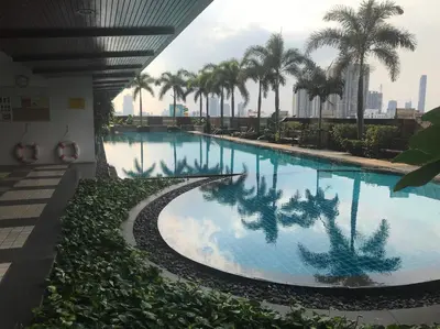 a large swimming pool with palm trees in a building at \u6eab\u99a8\u5c0f\u5c4b in Bangkok
