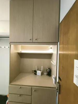 a kitchen with a cupboard and a refrigerator at \u6eab\u99a8\u5c0f\u5c4b in Bangkok