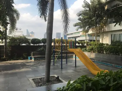 a playground with a yellow slide next to a palm tree at \u6eab\u99a8\u5c0f\u5c4b in Bangkok