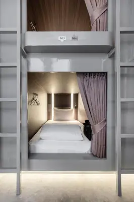 a small bed in a bunk bed room at Nidhra Boutique Hotel Bangkok Sukhumvit in Bangkok