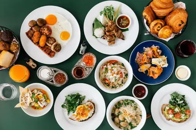 a group of plates of food on a table at The Standard, Bangkok Mahanakhon in Bangkok