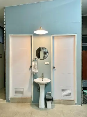 a bathroom with two doors and a sink at Dara Three Hostel ดาราตรี in Bangkok