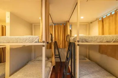a group of bunk beds in a room at Dara Three Hostel ดาราตรี in Bangkok