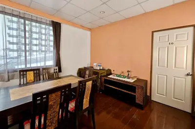 a dining room with a table and chairs and a window at Baan Glang Soi Restaurant & Guesthouse in Bangkok