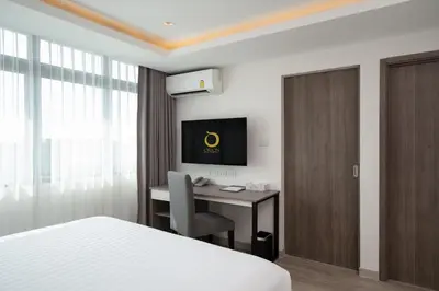 a hotel room with a desk and a bed at ORION Hotel & Residence Bangna in Bangkok