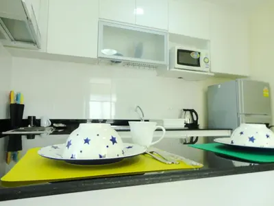 a kitchen counter with two plates and a cup on it at Charming Resident near BTS Ekkamai Station in Bangkok