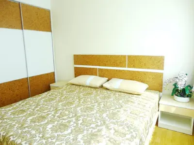 a bedroom with a bed with two pillows on it at Charming Resident near BTS Ekkamai Station in Bangkok